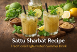 Sattu sharbat recipe served chilled in glasses with mint leaves, lemon slices, roasted cumin powder, and roasted gram flour on a rustic wooden table.